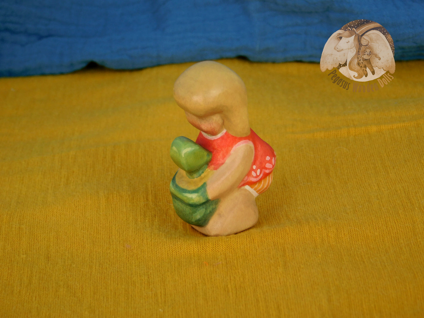 Wooden Squatting Baby in red dress with sand play set