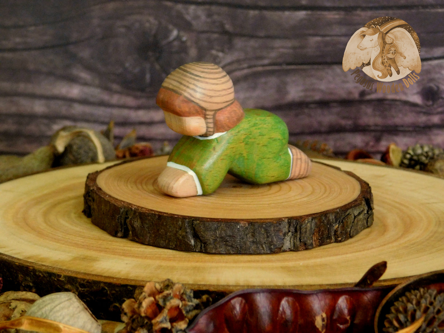 Wooden Crawling Baby in green clothes