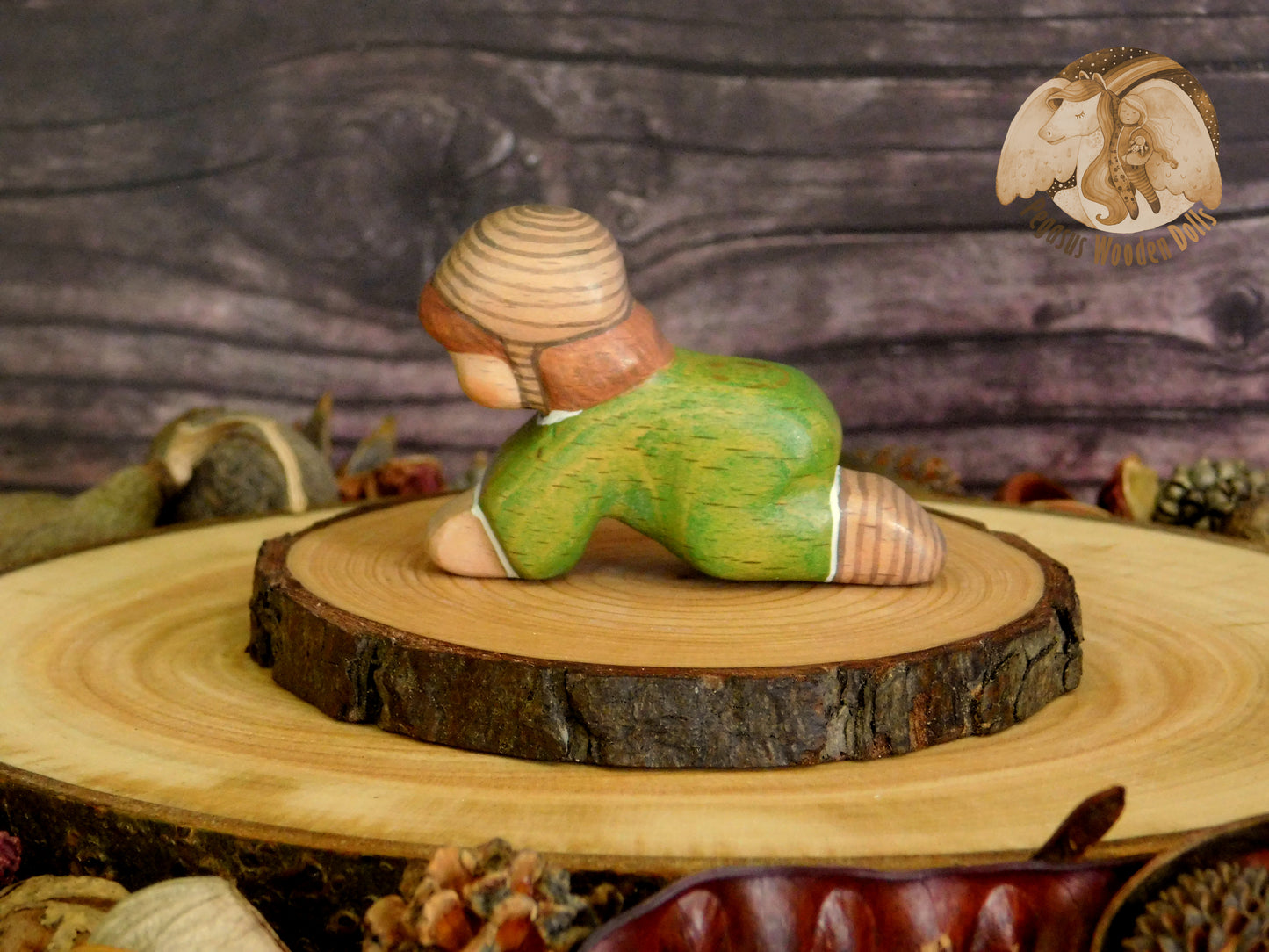 Wooden Crawling Baby in green clothes