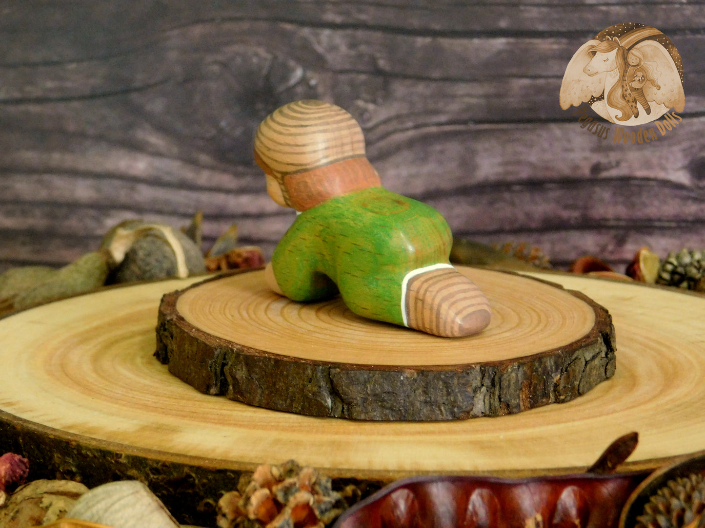 Wooden Crawling Baby in green clothes