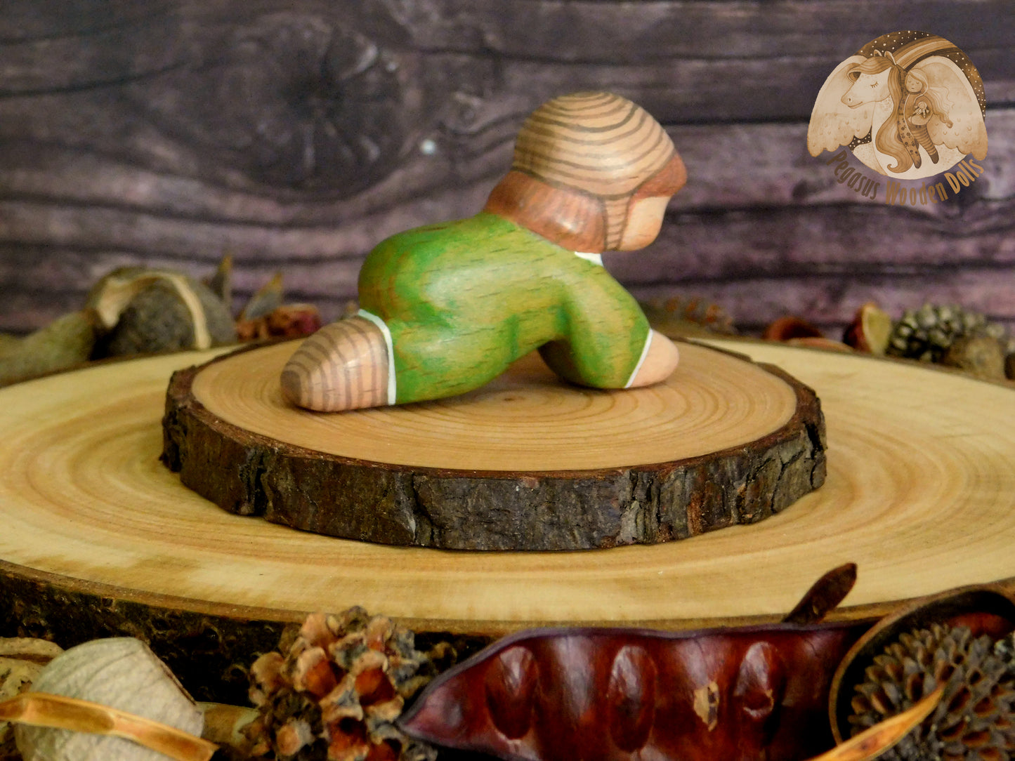 Wooden Crawling Baby in green clothes