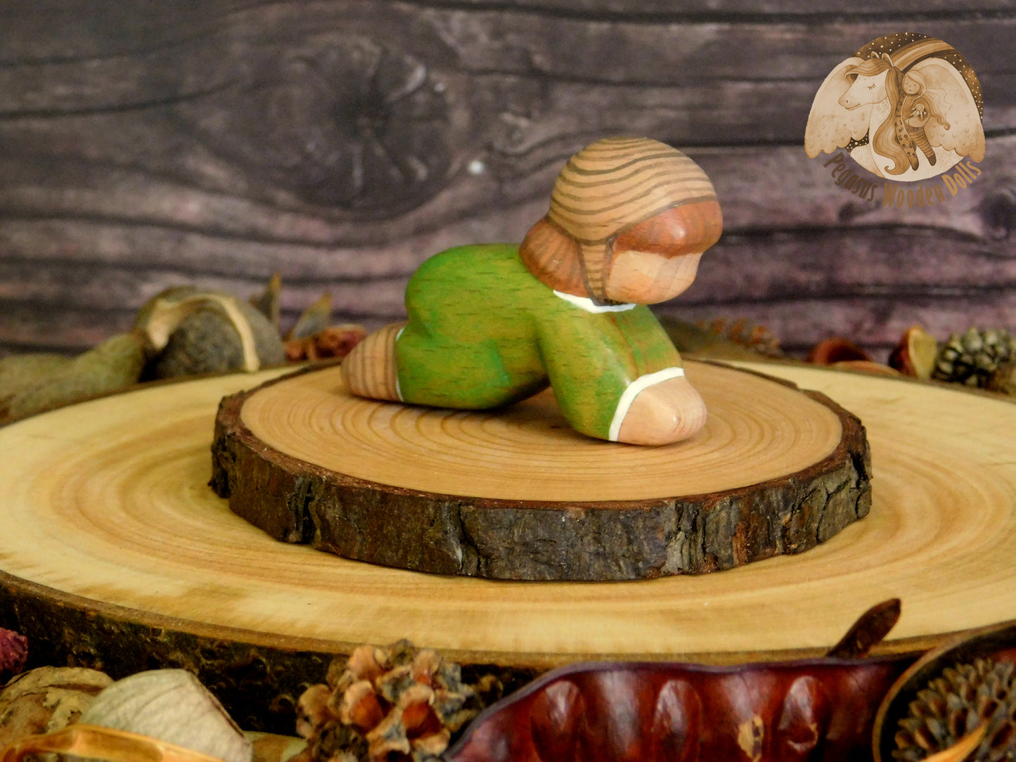 Wooden Crawling Baby in green clothes