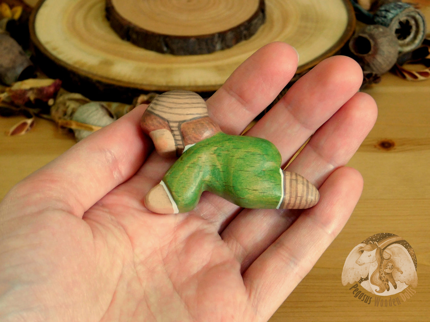 Wooden Crawling Baby in green clothes
